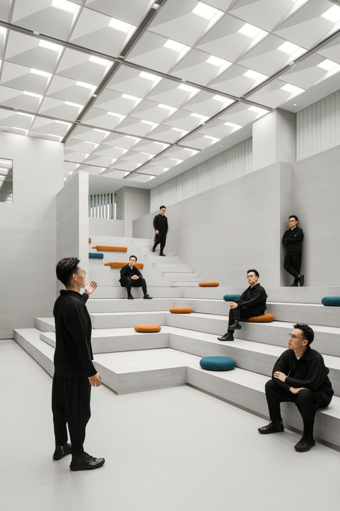Stepped auditorium seating with orange and teal felt cushions