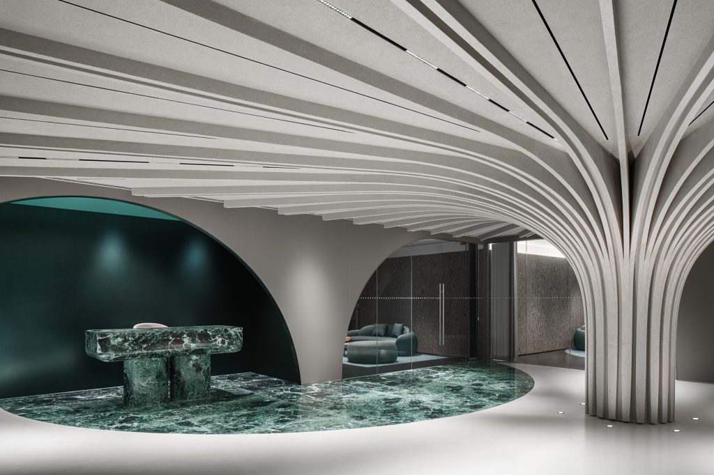 Sculptural tree column with radiating felt fins over a green-marble reception plinth on the fifth floor