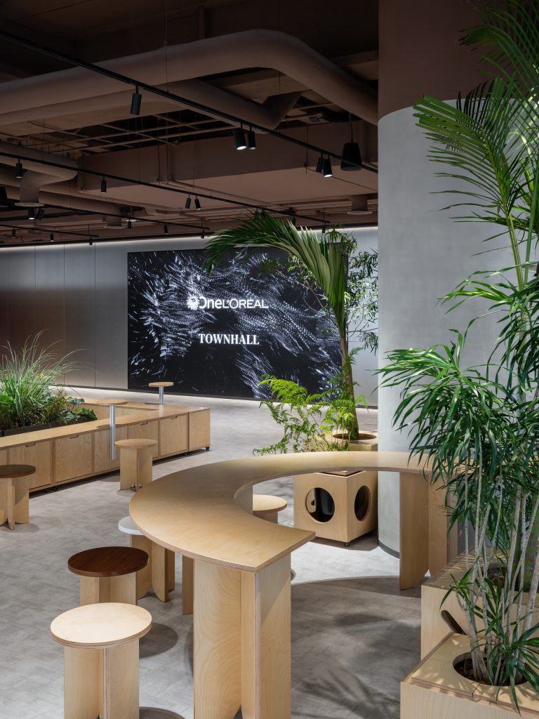 The Grand Pantry configured for a townhall, curved plywood benches facing a large LED wall