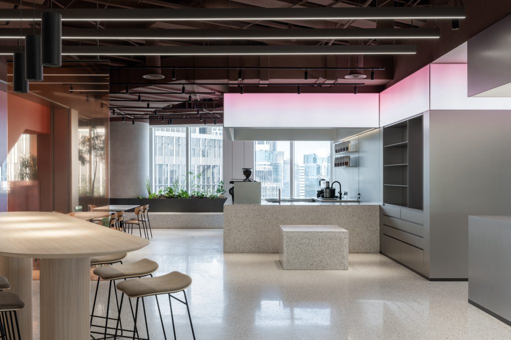 Terrazzo coffee island beneath a pink gradient lightbox, the Shanghai skyline beyond