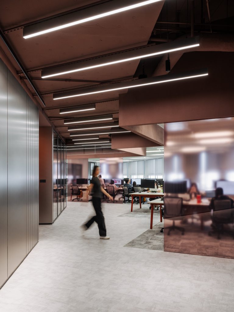 Workspace neighbourhood seen past bronze panelling and rose-tinted glass