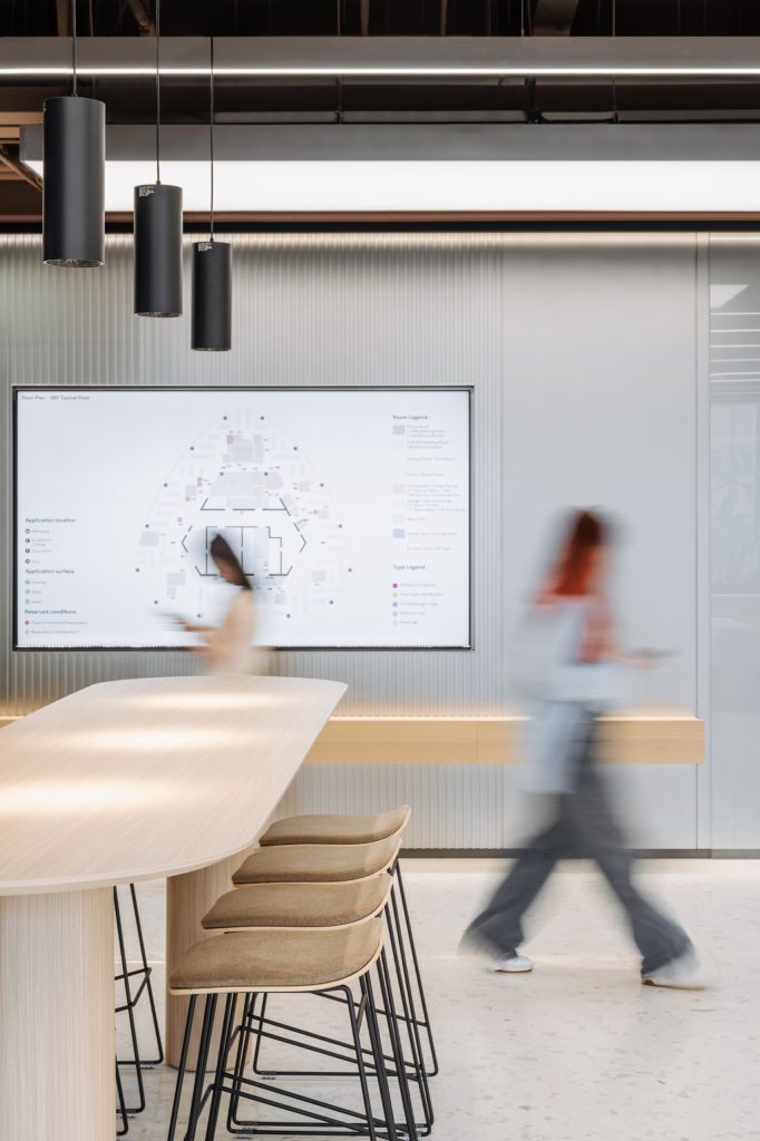 Cafe-style training space with terracotta brick walls, a peach kitchen and mixed timber chairs